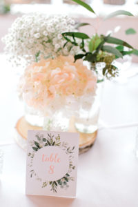 Hydrangea and babies breath flowers in peachy tone on reception table at Studio D2D Grand Rapids Wedding venue
